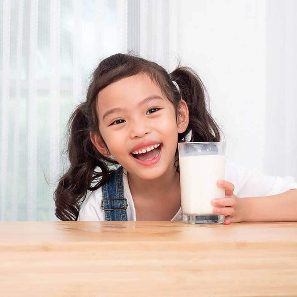 Why do school-age children need to drink enough milk each day?